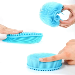 Blue silicone bath brush with double-sided bristles showing flexible material and soft texture