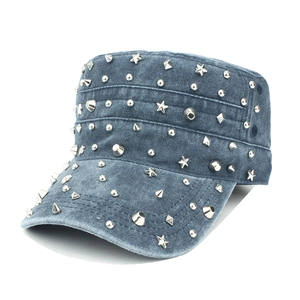 Close-up of vintage washed denim military cap with mixed metal studs and silver stars