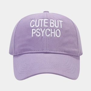 Detail of lavender cotton baseball cap with white CUTE BUT PSYCHO embroidery text