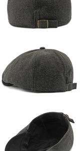 Detail of dark grey herringbone newsboy cap featuring metal buckle and inner lining