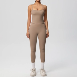 Detail of high-waist yoga leggings and beige crop top in matte high-stretch fabric
