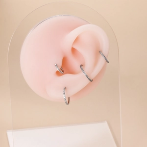 G23 titanium nose rings with cubic zirconia pavé set on a silicone ear model