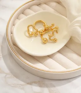 Detail of a vintage pearl and steel bead bracelet on a white porcelain dish closeup