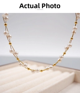 Macro detail of hand-woven pearl and gold bead choker with elegant crisscross pattern