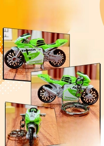 Detail of green PVC motorcycle model keychain with metal ring and cool racing graphics