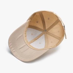 Internal view of khaki baseball cap featuring reinforced seams and metal adjustment buckle