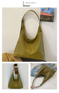 Detail view of large green hobo bag featuring vertical stitching and adjustable strap