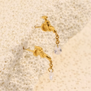 Macro shot of 18K gold-plated faucet stud earrings with sparkling zircon water drop charms