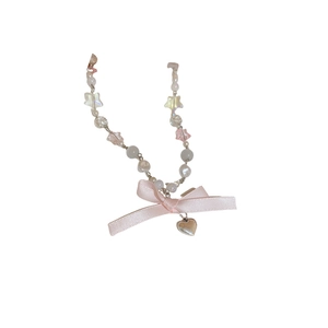 Pink ribbon bow necklace with opal heart pendant and crystal star beads on white background