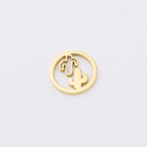 Detail shot of a golden metal round pendant with hollow cactus design for DIY jewelry