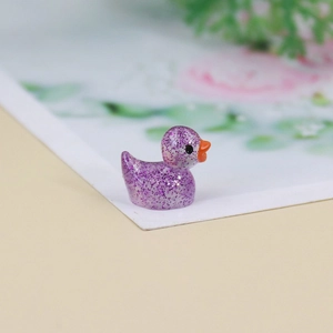 Macro view of a purple glitter resin miniature duck figurine for micro landscape decor