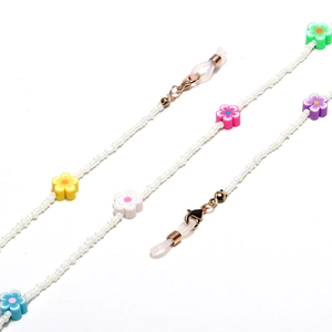 Close-up of beaded glasses chain with colorful clay flowers and golden lobster clasps