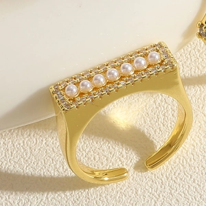 Close-up of 14K gold plated bamboo ring with inlaid pearls and sparkling cubic zirconia
