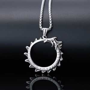 Detailed shot of silver stainless steel dragon pendant with Norse runes and link chain
