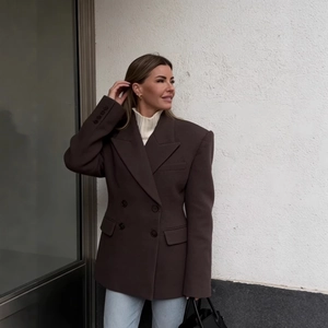 Women's chocolate brown double-breasted blazer with structured shoulders in a business casual style