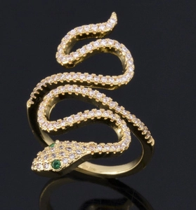 Fashionable gold snake ring featuring white pave zircons and green gemstone eyes