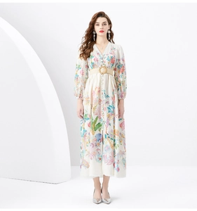 Detail of V-neck lace trim and tropical floral print on a white bohemian maxi dress