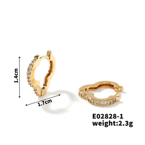 Detail of gold heart earrings with white cubic zirconia, size 1.4cm by 1.7cm