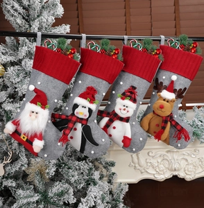Set of 4 hanging Christmas stockings with 3D Santa, penguin, and snowman characters