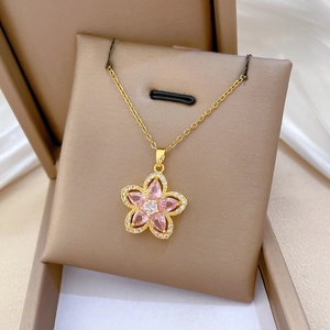 Close-up of a pink floral pendant with crystals in a premium gift box setup