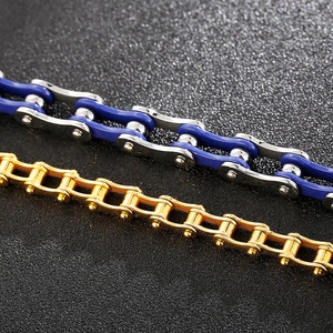 Detail shot of heavy bicycle chain bracelets in blue-silver and golden finishes