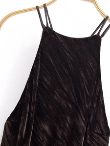 Detail of the dark brown velvet sleeveless dress with premium ribbed texture and tassel hem