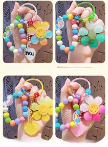 Close-up of colorful beaded sun flower keychains with rainbow heart and love charms