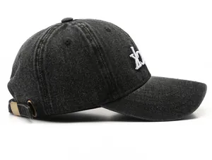 Side view of washed charcoal baseball cap with white XO embroidery and metal adjustment buckle
