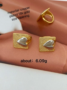 Macro detail of mixed-metal heart ring in 18k gold plated copper with zircon stones