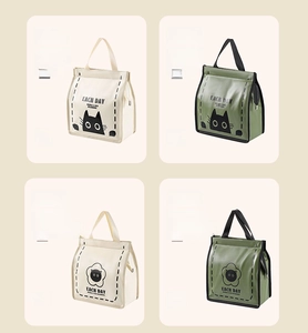 Detail view of cartoon lunch bags in creamy white and matcha green with cat patterns