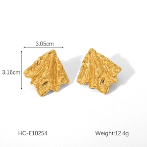Detailed view of 18K gold plated stainless steel earrings with hammered lava texture