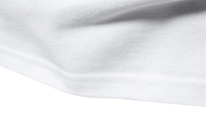 Close-up of white pique knit fabric texture and precision stitching on polo shirt hem