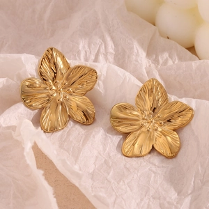 Macro shot of 18K gold plated petal earrings showing fine radial texture details