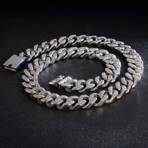 Silver Cuban link chain necklace with polished stainless steel links on dark background
