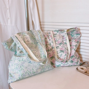 Detailed close-up of floral cotton tote bags with sturdy straps and vintage aesthetic prints