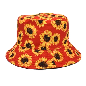 Detailed view of red bucket hat featuring vibrant yellow sunflower prints on cotton fabric