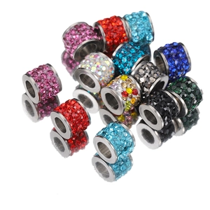 Colorful rhinestone spacer beads for DIY jewelry making on a reflective white surface