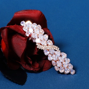 Close-up of sparkling pear-shaped zircon stones set in a gold twisted spring hair clip