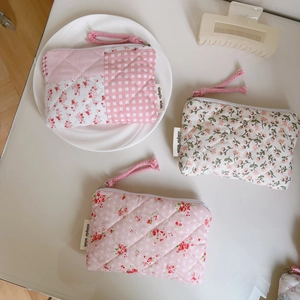 Three quilted cotton mini pouches with pink floral patterns and secure zip closure