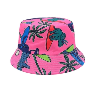 Close-up of pink sun hat featuring colorful cartoon dinosaur and palm tree prints