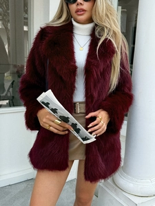 Detailed macro view of elegant wine red faux fur coat fabric with premium plush texture