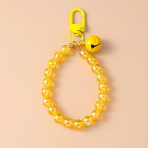 Detail of yellow iridescent beaded keychain with a metal bell and spring clasp closure