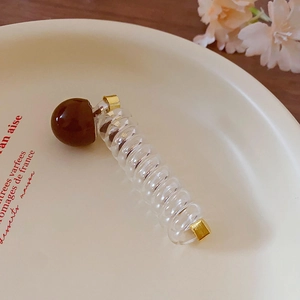 Transparent telephone wire hair band with brown bead for sweet daily fashion styling.