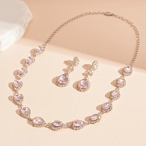 Detail of pink pear-cut gemstone jewelry set with necklace and earrings in silver