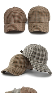 Detailed view of houndstooth wool baseball caps in brown and beige tones