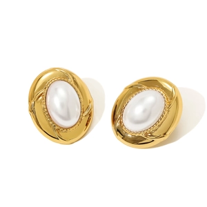 Detail view of oval gold alloy earrings with white pearls and French vintage relief