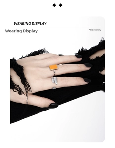 Detail of S925 silver square orange turquoise ring and feather ring on model's hand