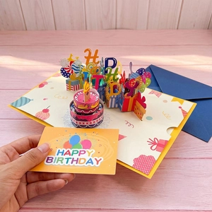 Detailed 3D pop-up birthday card with a cake design, matching small card, and blue envelope