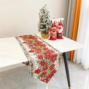 Close-up of Christmas table runner with red floral jacquard patterns and white tassels