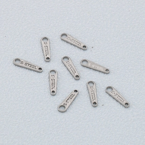 Polished silver stainless steel letter tags engraved with S.STEEL for jewelry making